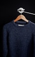 black crew neck sweater on white clothes hanger