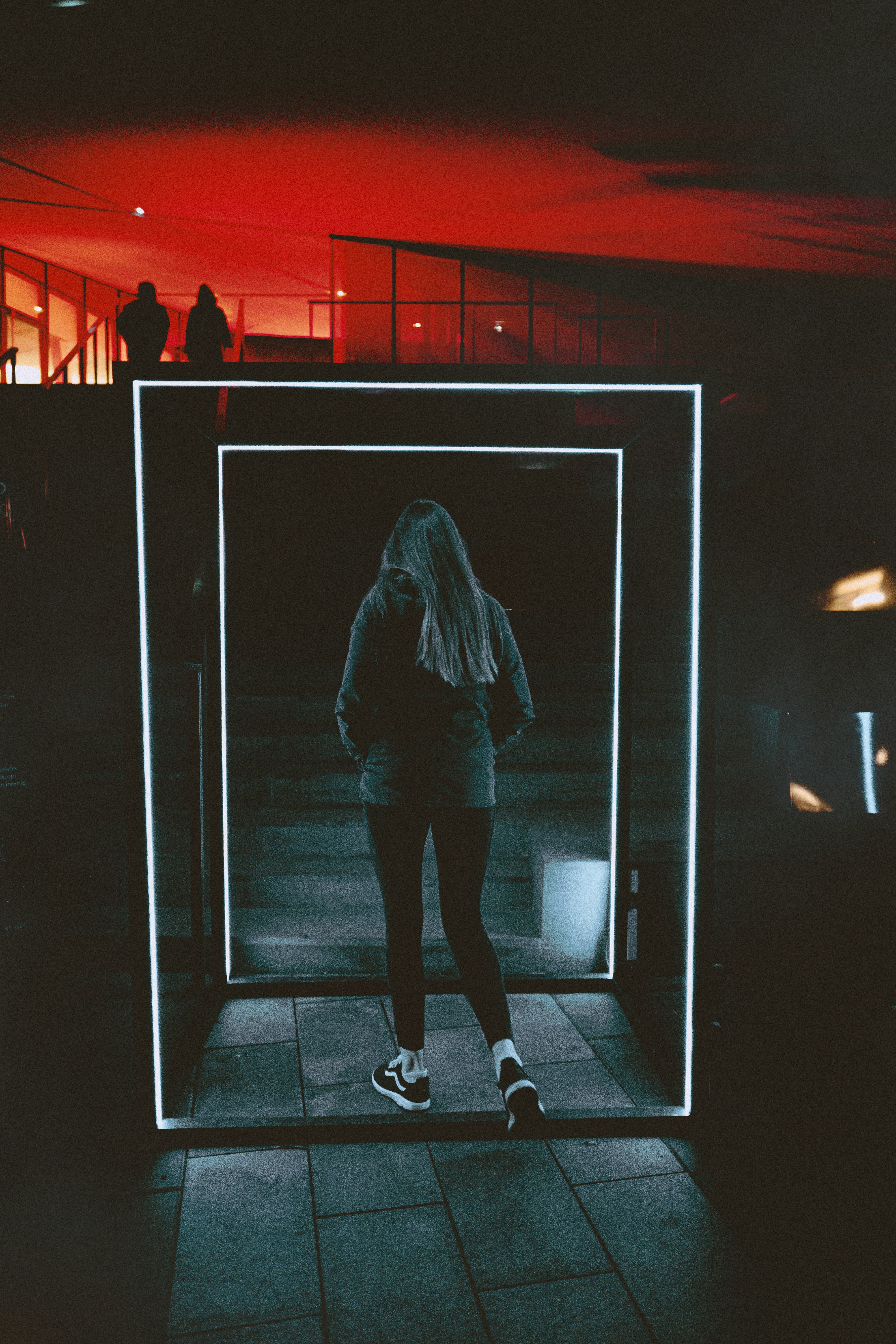 woman in black jacket and black pants standing in front of mirror