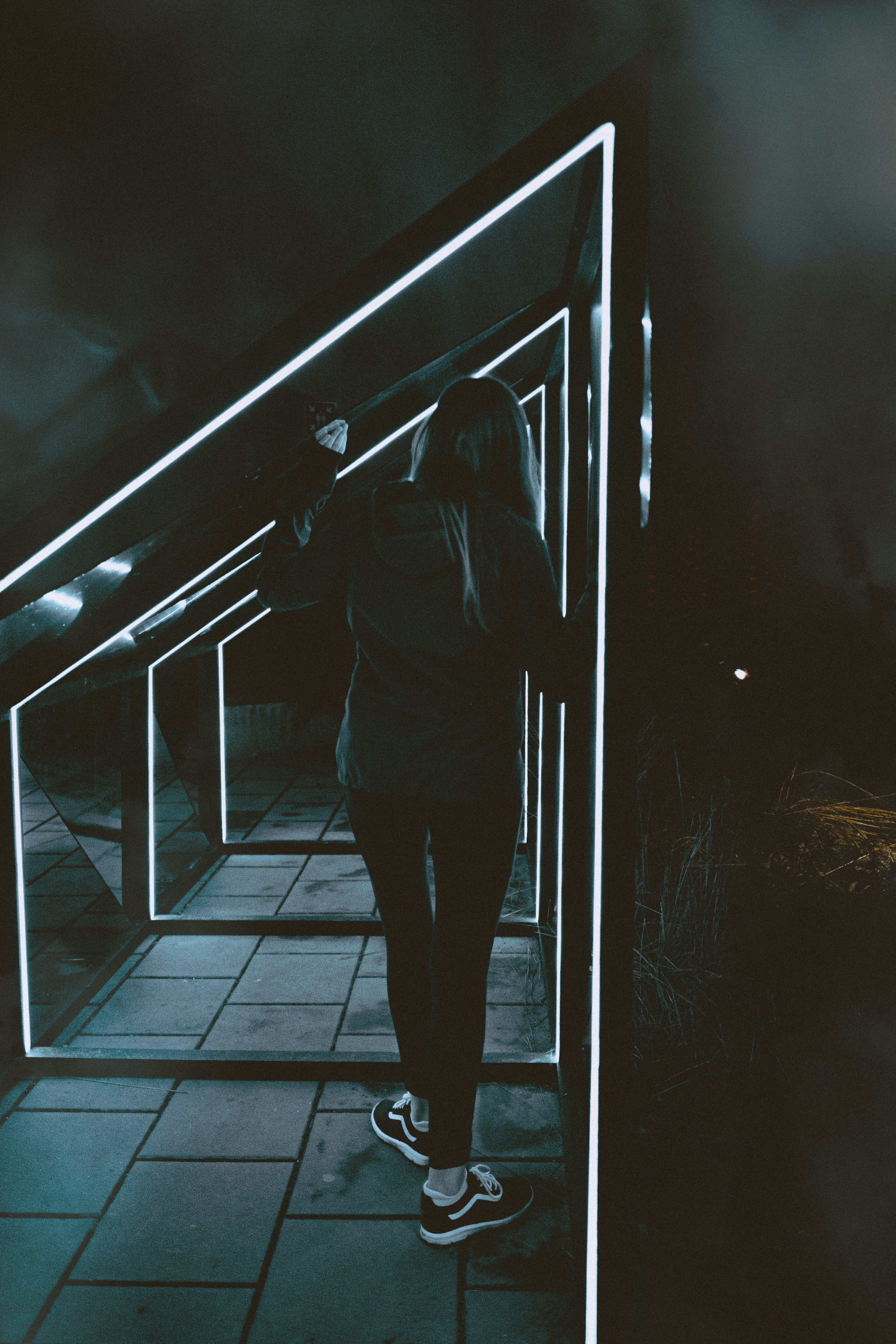 woman in black jacket standing on train station