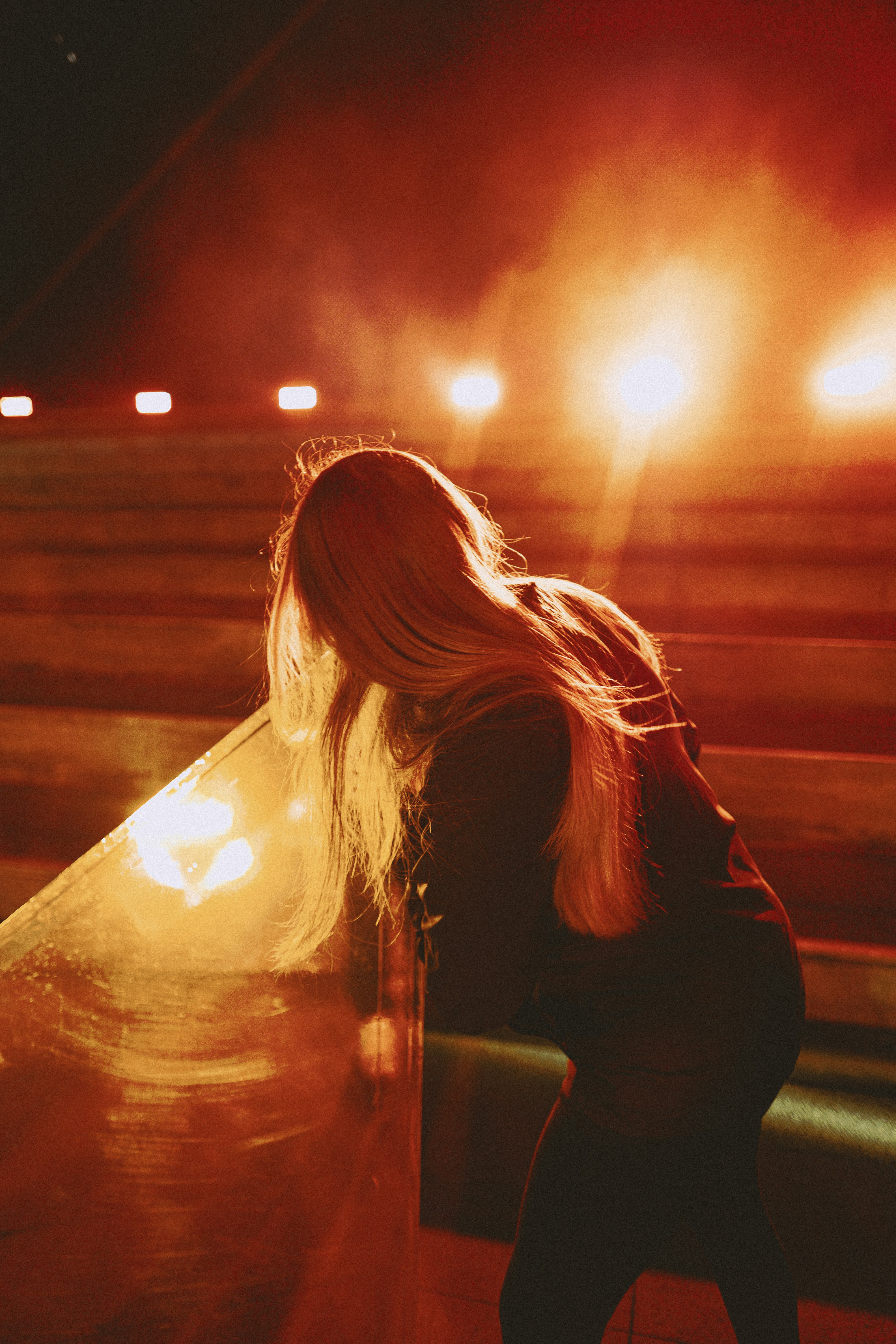 woman in black long sleeve shirt holding clear drinking glass