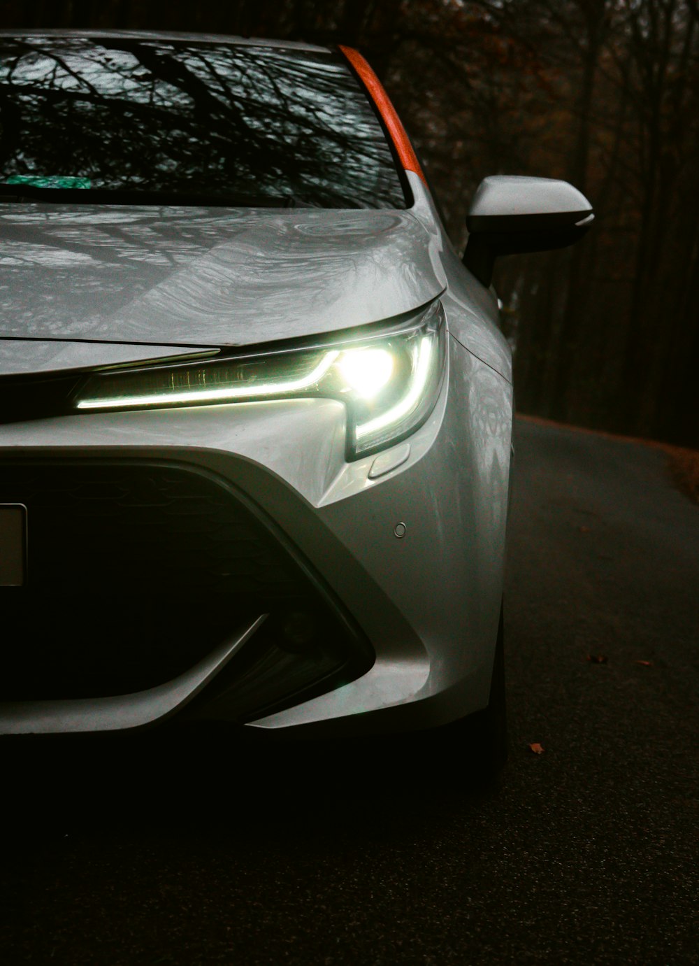 silver car on gray asphalt road during night time