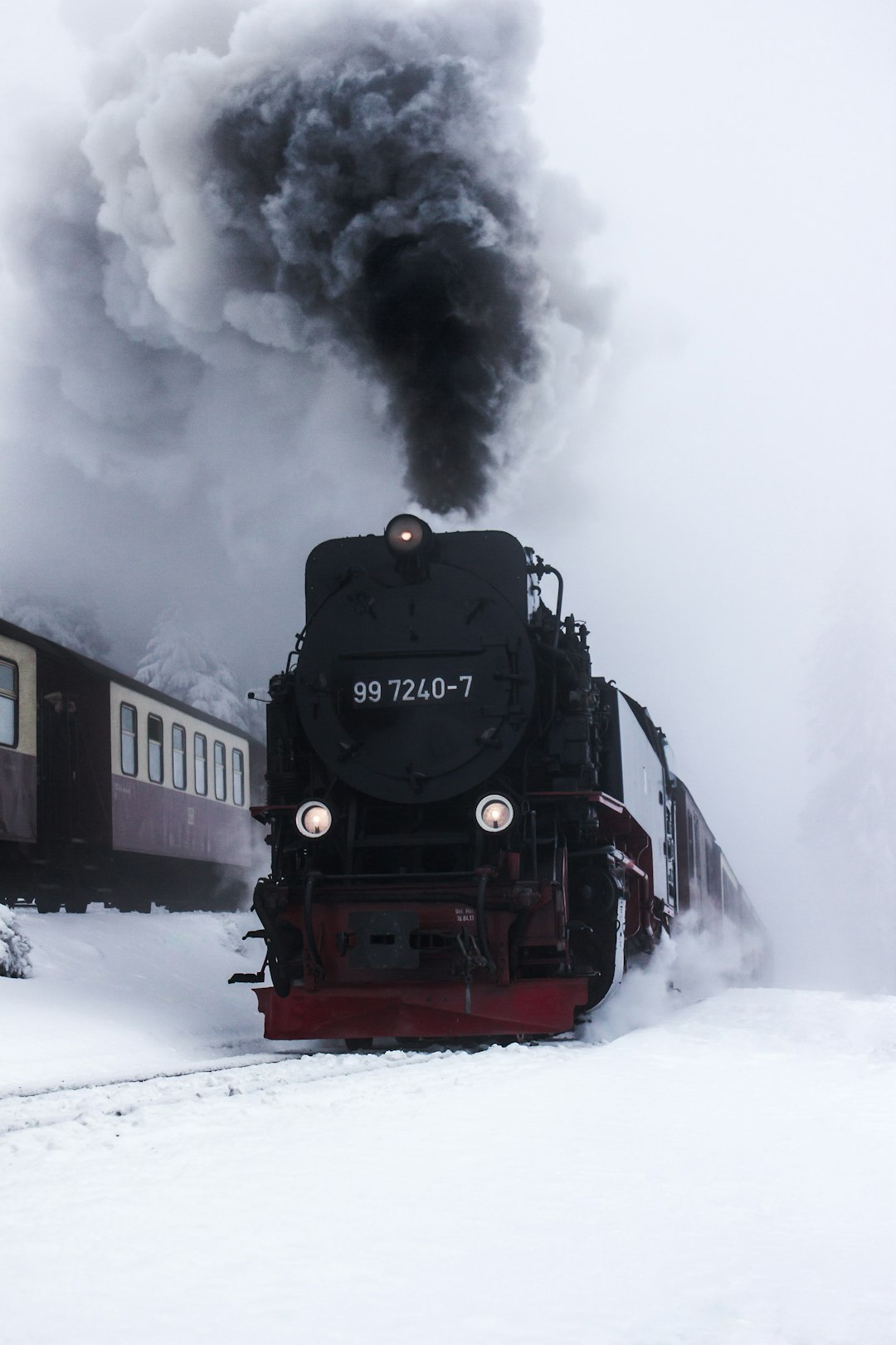 black and red train on snow covered ground during daytime