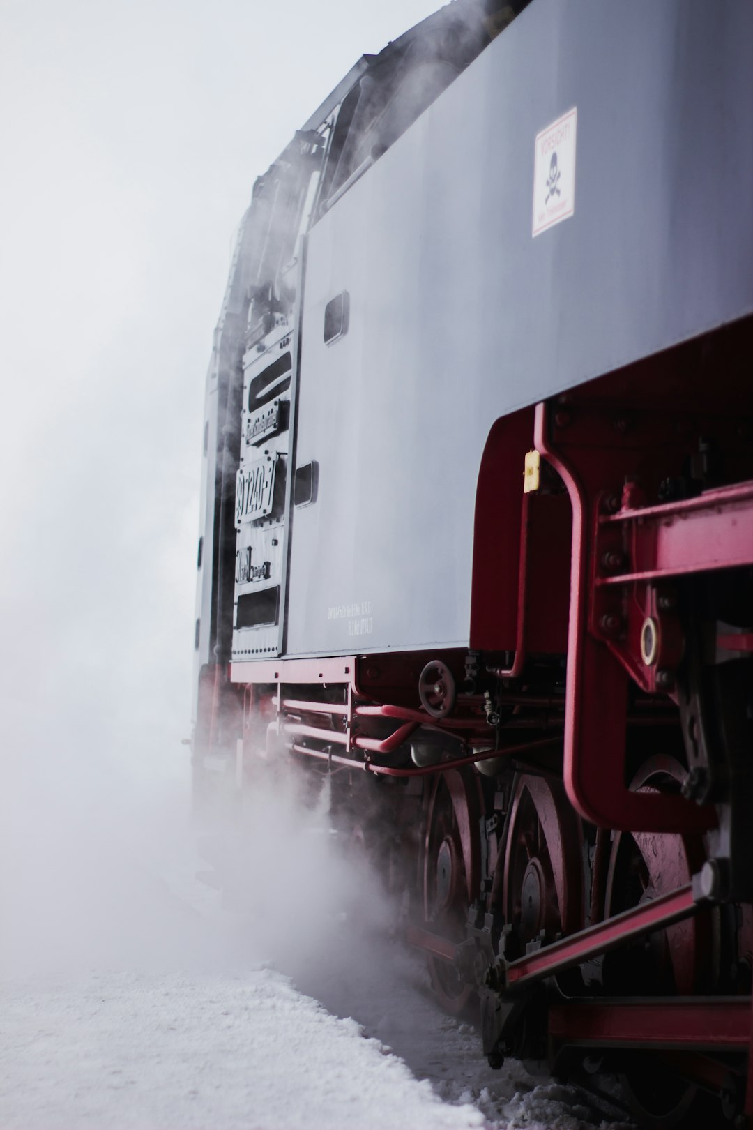 black and red train on rail tracks