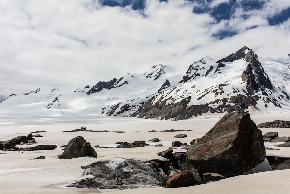 snow covered mountain under white clouds during daytime