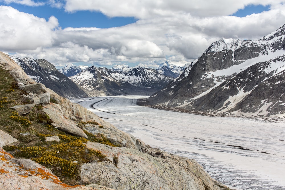 snow covered mountain under cloudy sky during daytime