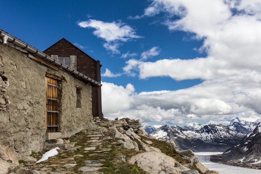 Edificio de ladrillo marrón en suelo cubierto de nieve bajo cielo nublado azul y blanco durante el día