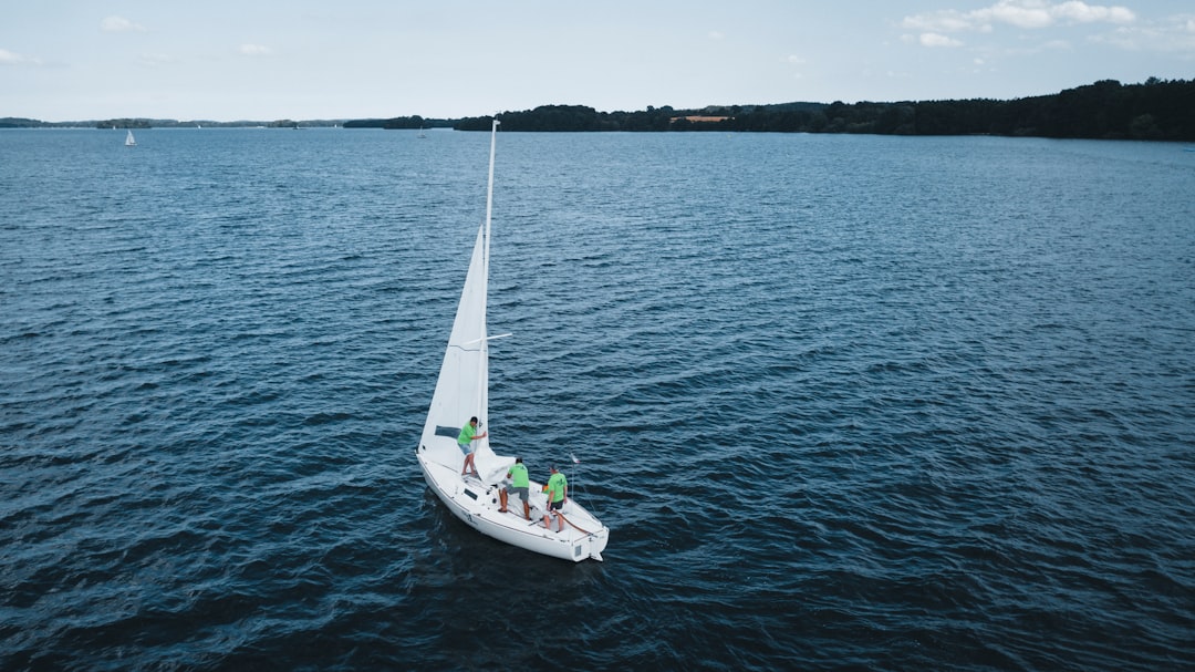 white boat on sea during daytime