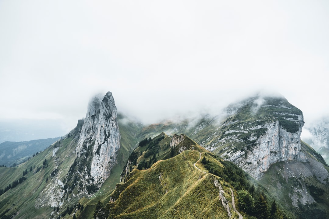 green and gray mountain under white clouds during daytime