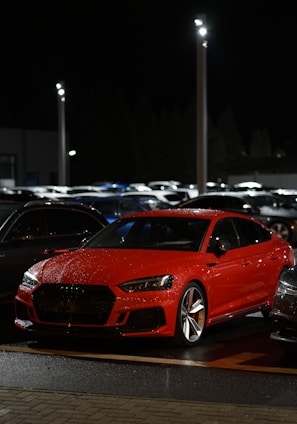 red bmw m 3 parked on parking lot during daytime