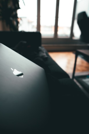 Close-up of a satisfied customer typing on a Meteks laptop in a cozy, sunlit room.