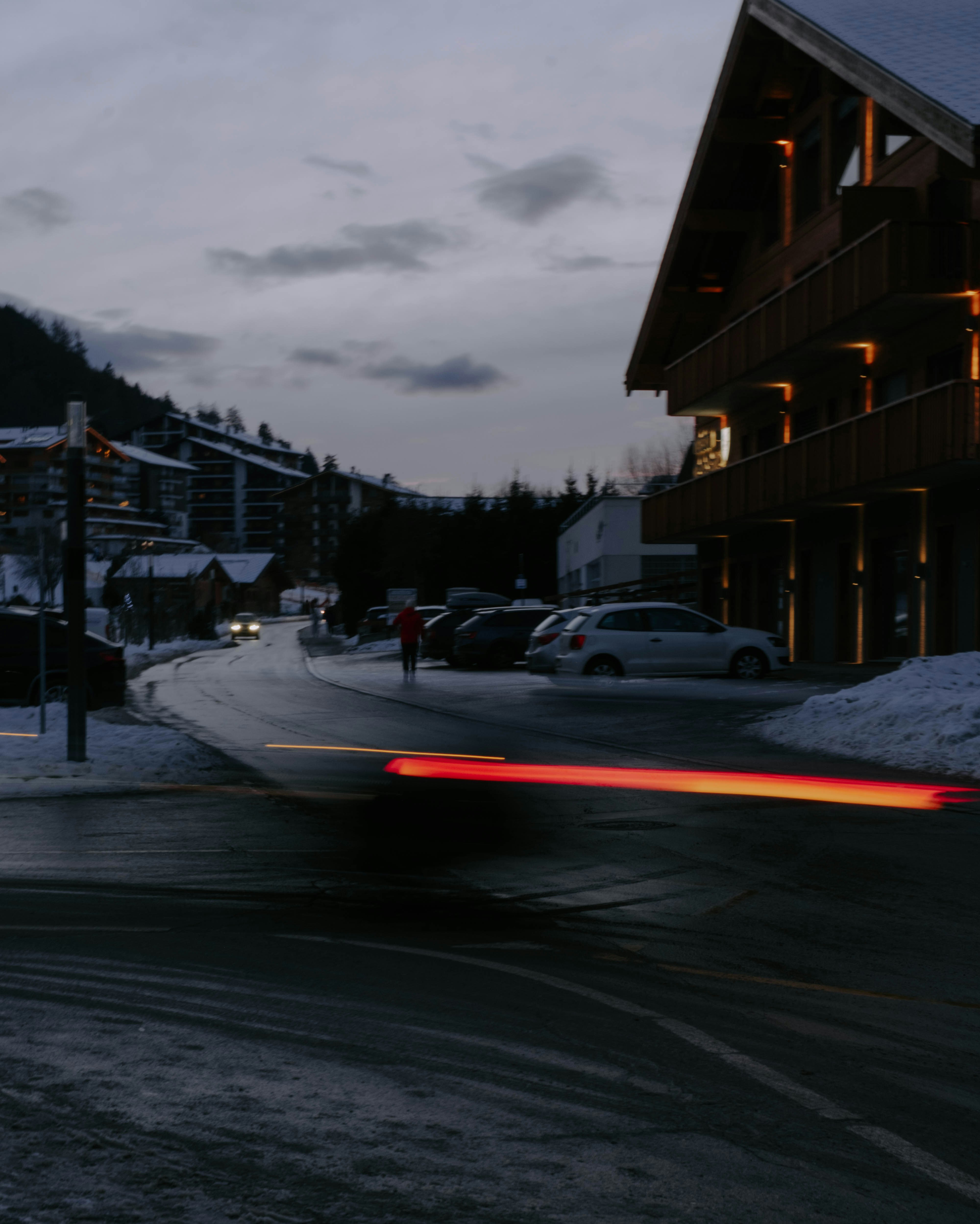 cars on road near buildings during night time