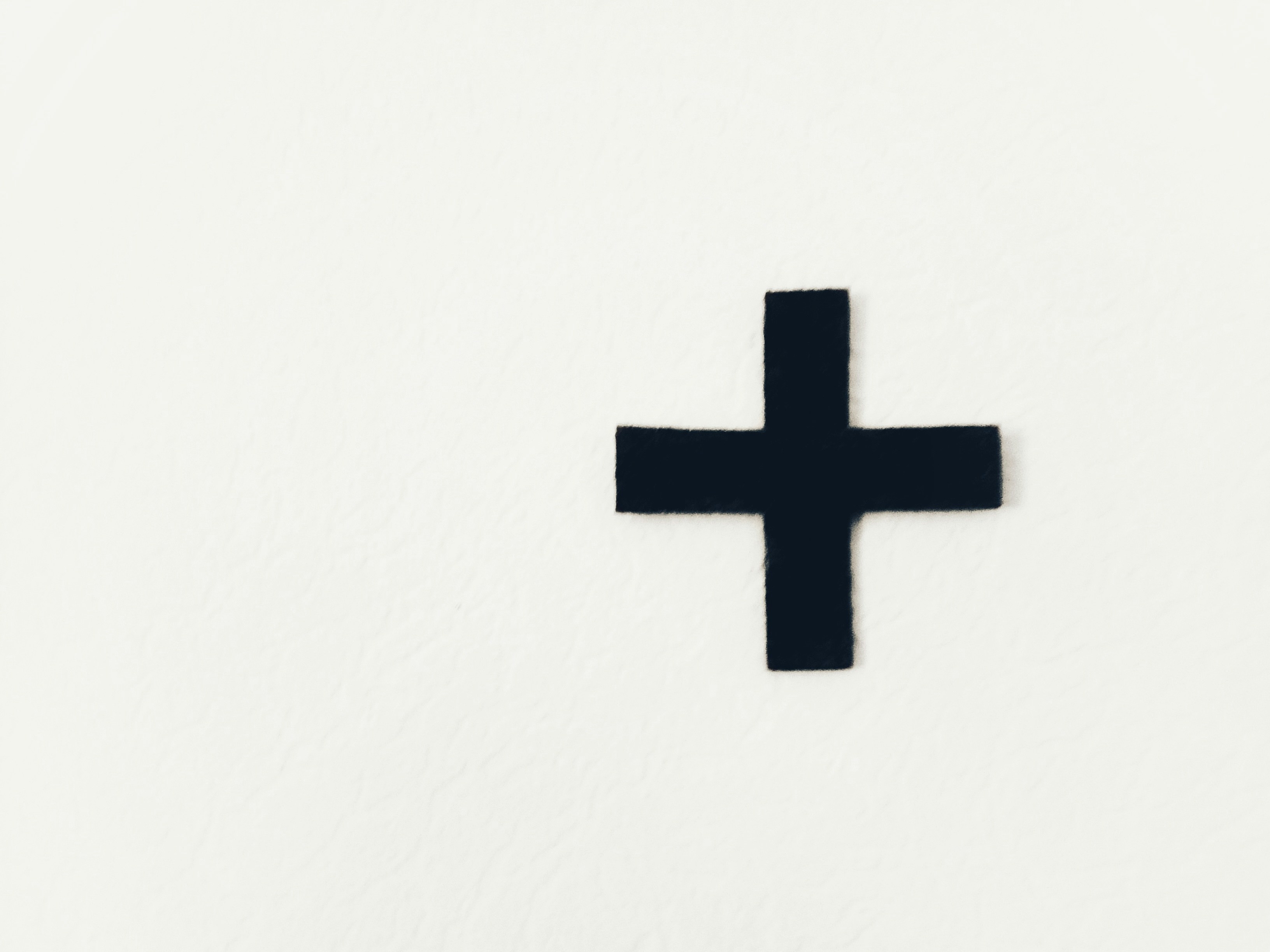 white cross on white background