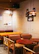 Warm, inviting café corner with soft lighting and minimalist décor in coffee browns and beige.
