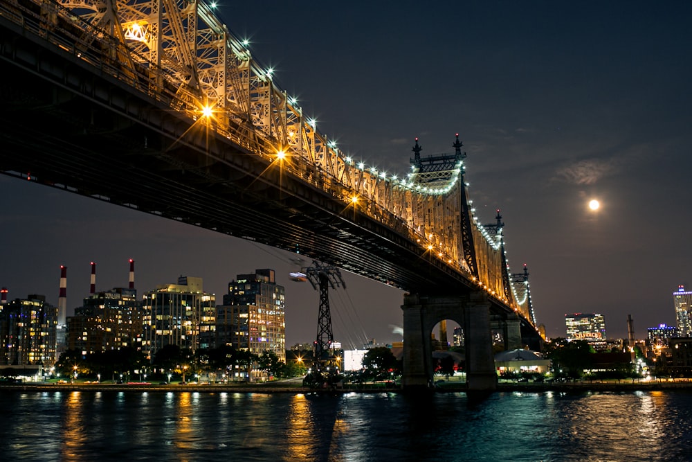 lighted bridge over water during night time