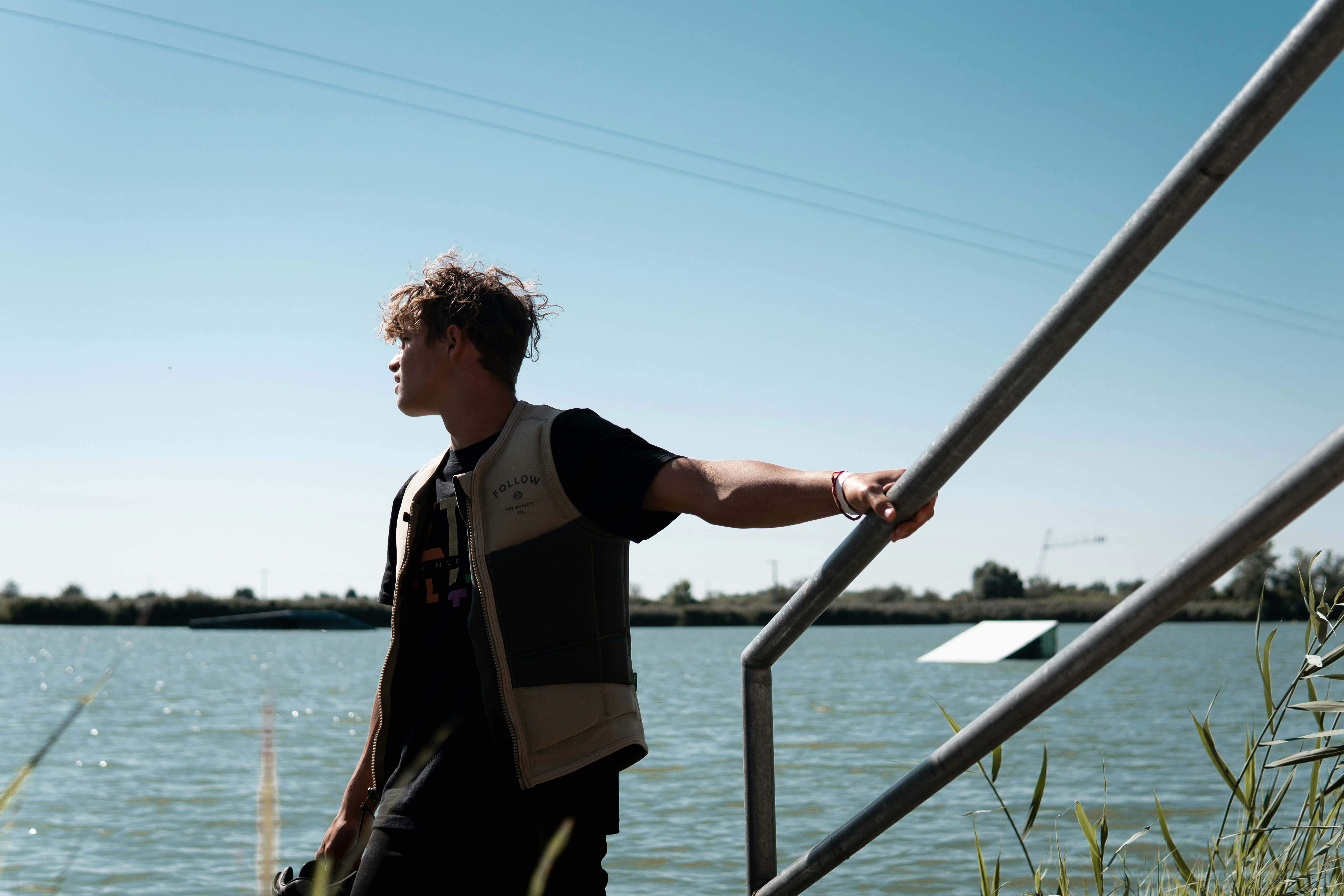 man in black jacket standing on boat during daytime