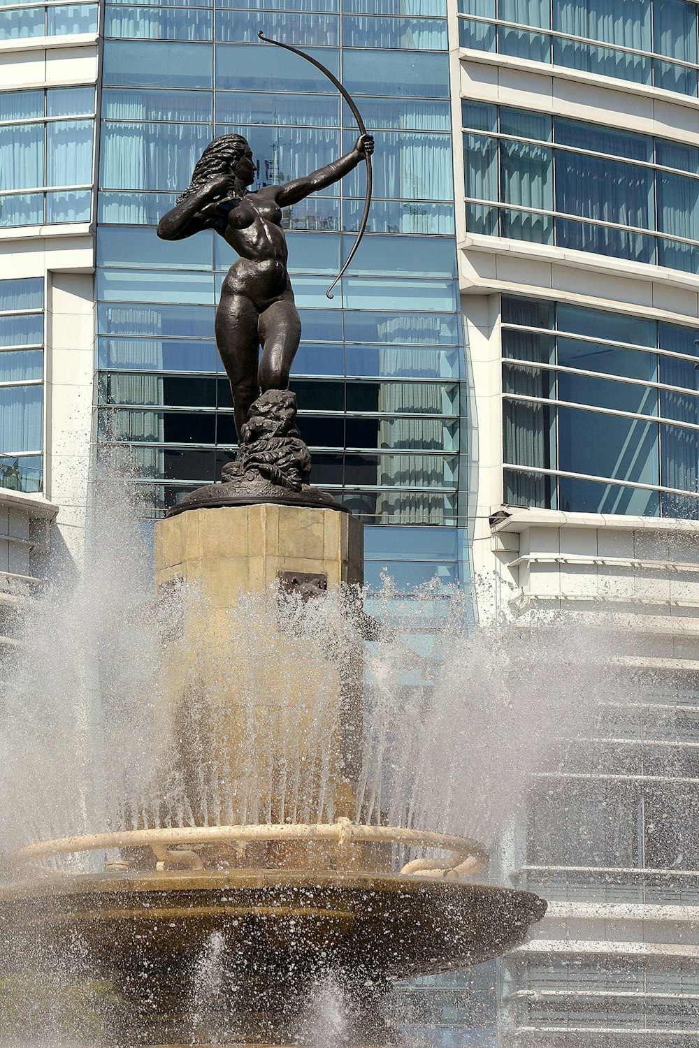 man statue in water fountain