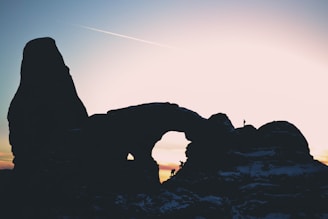 A group of researchers exploring the rocky formations of Cuesta at sunset.