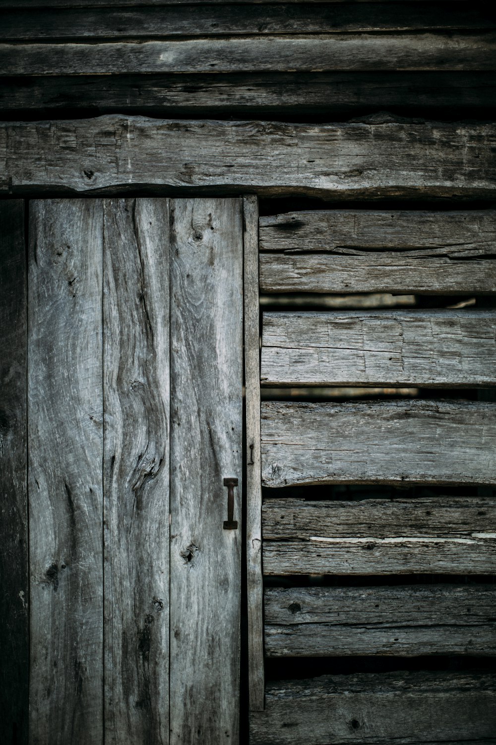 grayscale photo of wooden fence