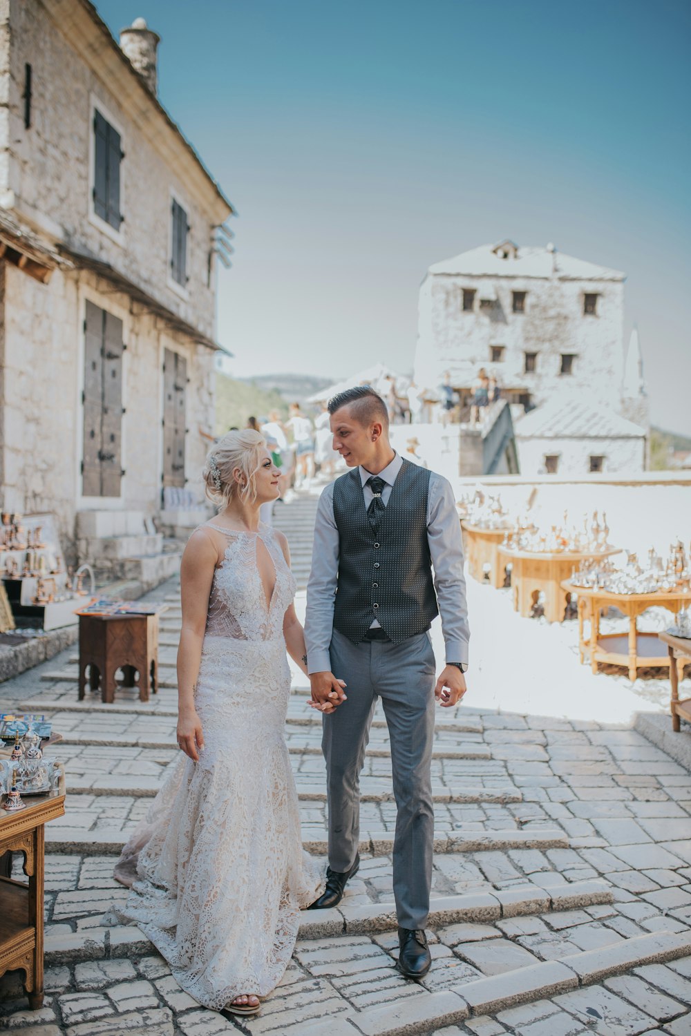 man and woman walking on sidewalk during daytime