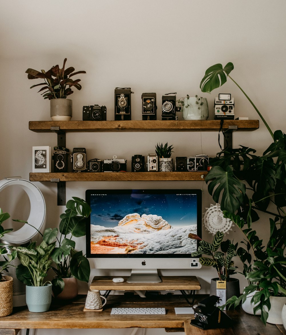 black flat screen tv on brown wooden wall mounted rack