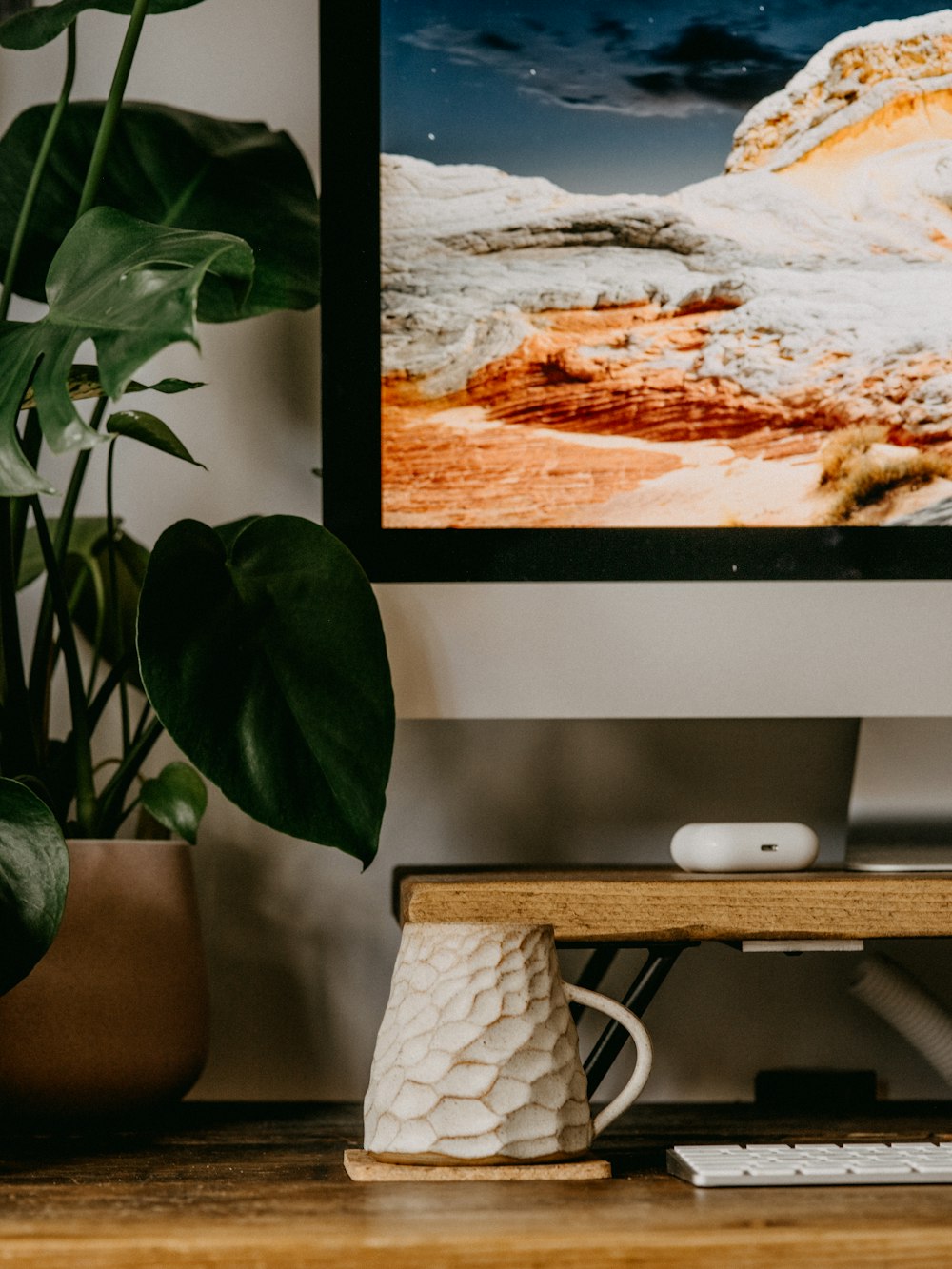 silver imac on brown wooden table