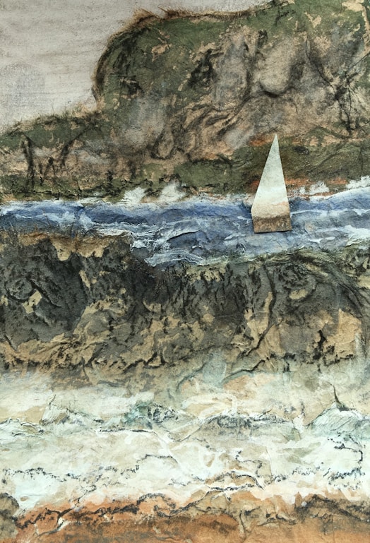 white sailboat on water near brown rock formation during daytime