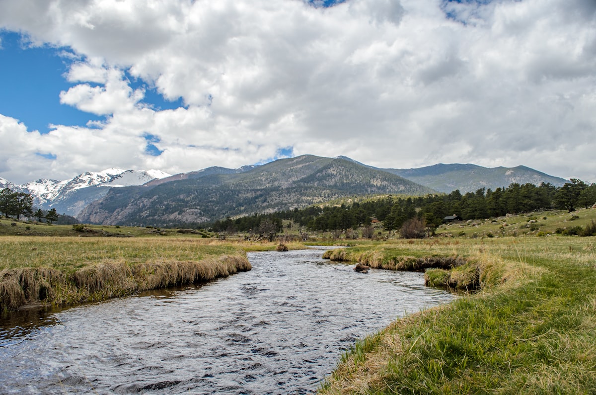 Mountain stream through meadow with peaks in background — RMNP, Colorado