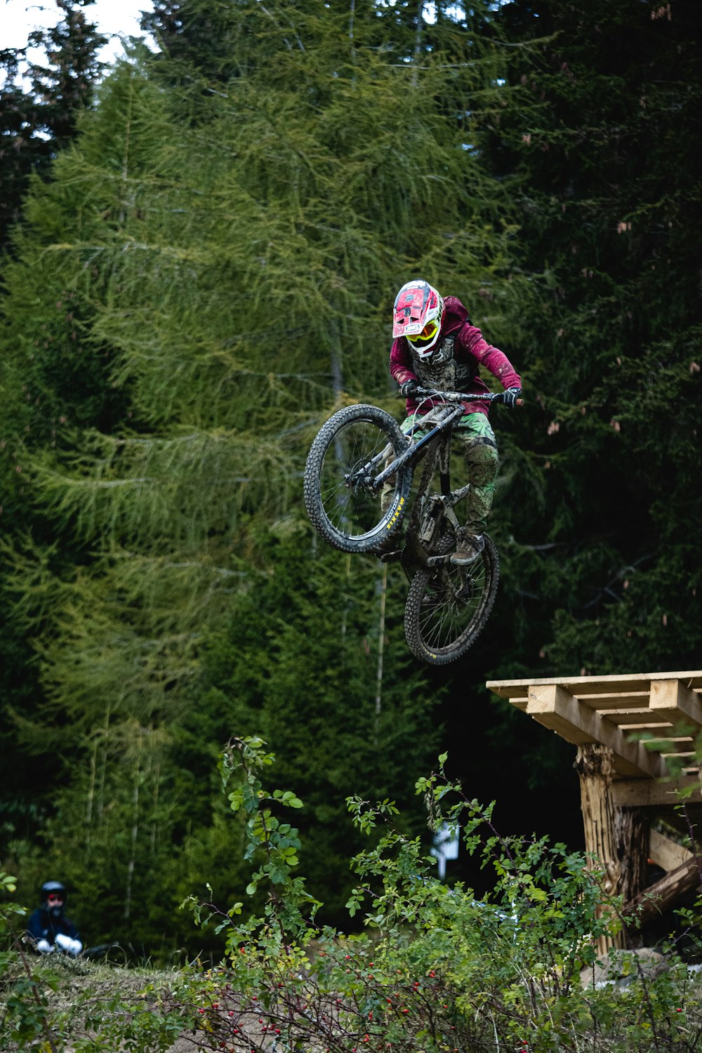 man in black jacket riding mountain bike on mountain during daytime