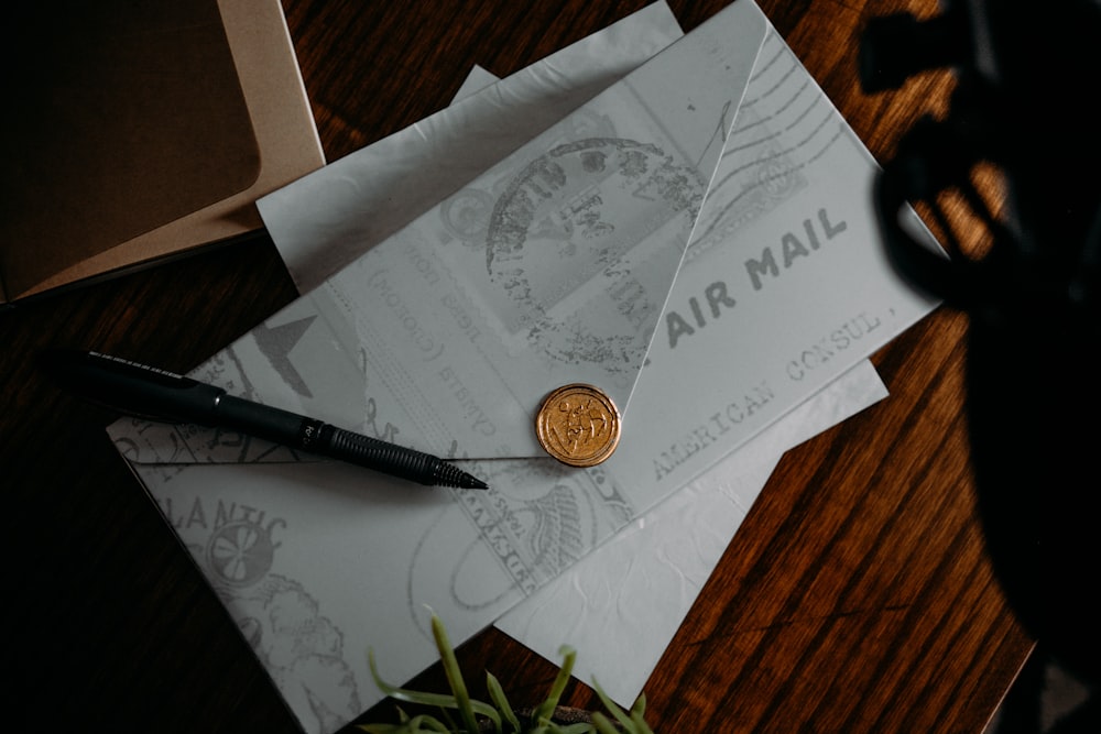 silver round coin on white printer paper