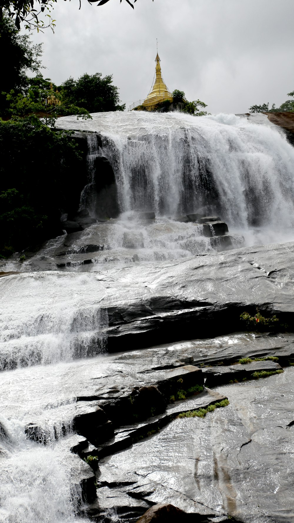 waterfalls on rocky mountain during daytime