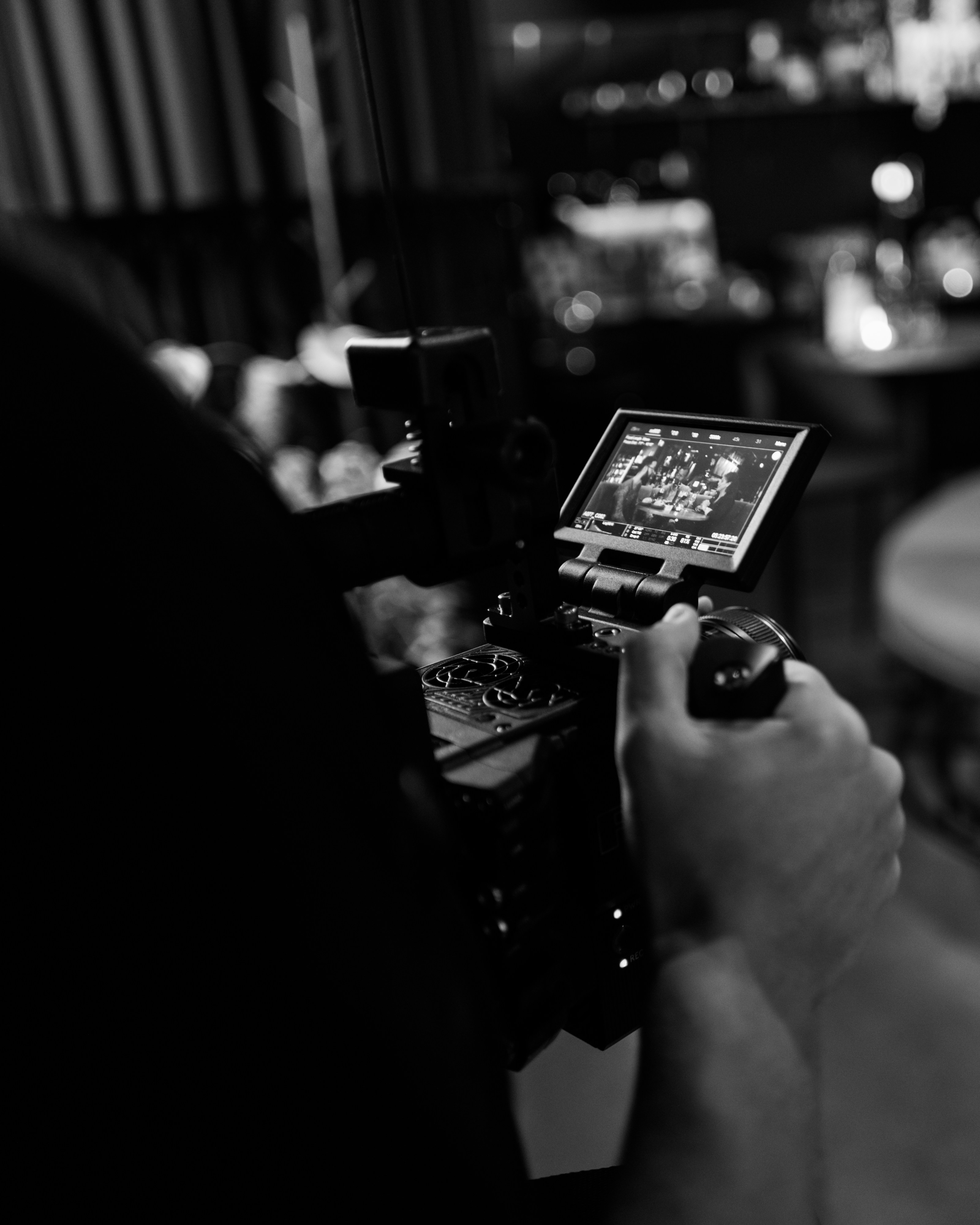 grayscale photo of person holding camera