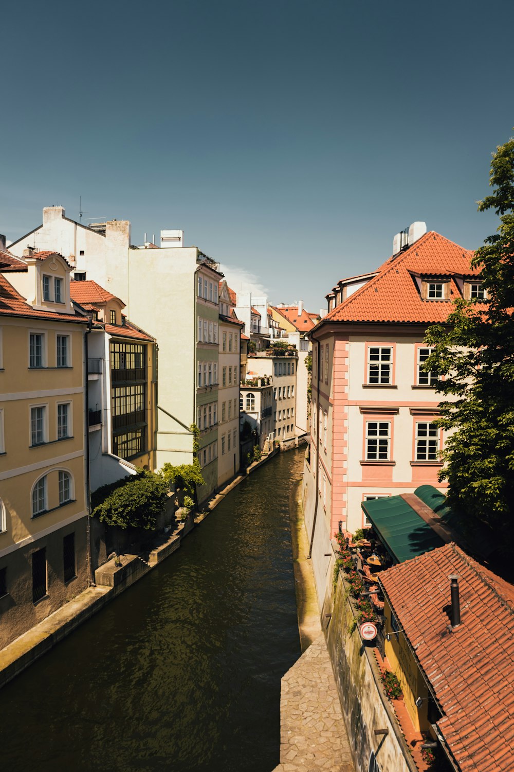 white and brown concrete building beside river during daytime