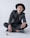 man in black blazer and black pants wearing black hat sitting on floor