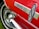 A close-up of a red car with a shiny chrome trim featuring the text 'Electra 225'. The image shows a part of a classic car's body including a stylized logo.