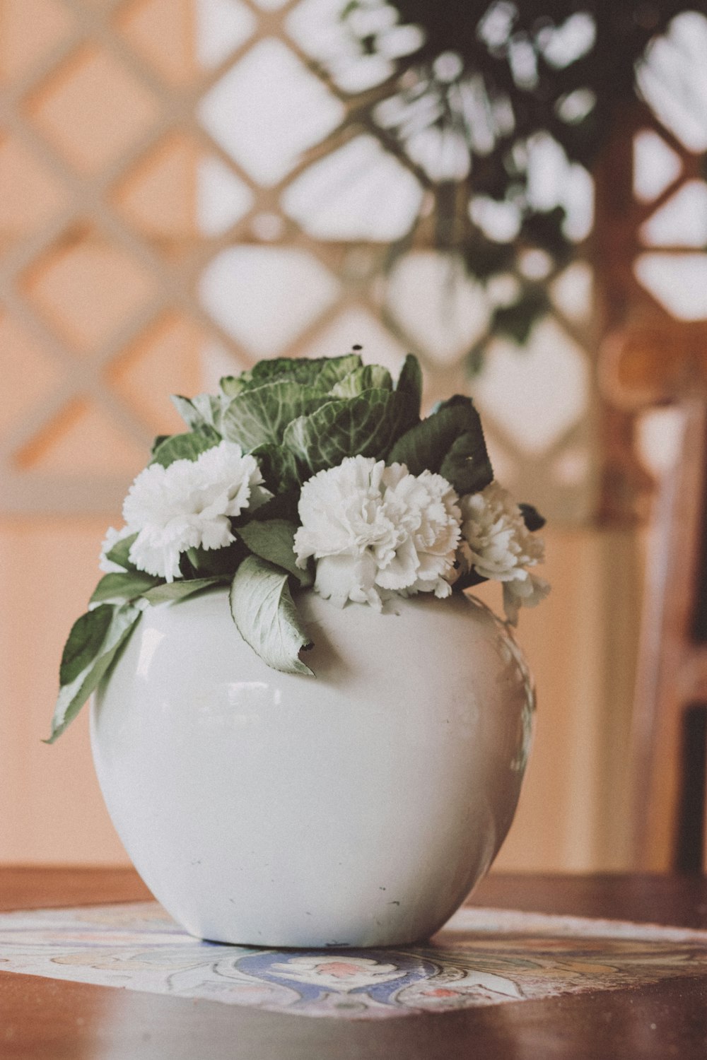 white flowers in white ceramic vase