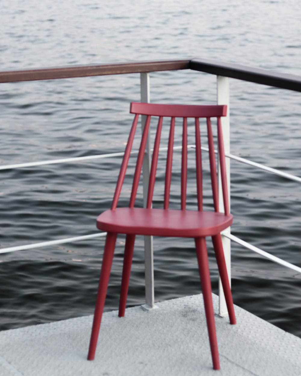 red wooden chair on gray concrete floor