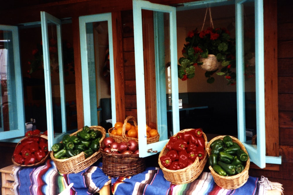 brown woven basket with green and red apples