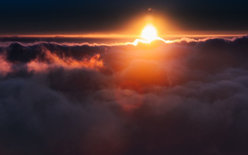 sun setting over the clouds