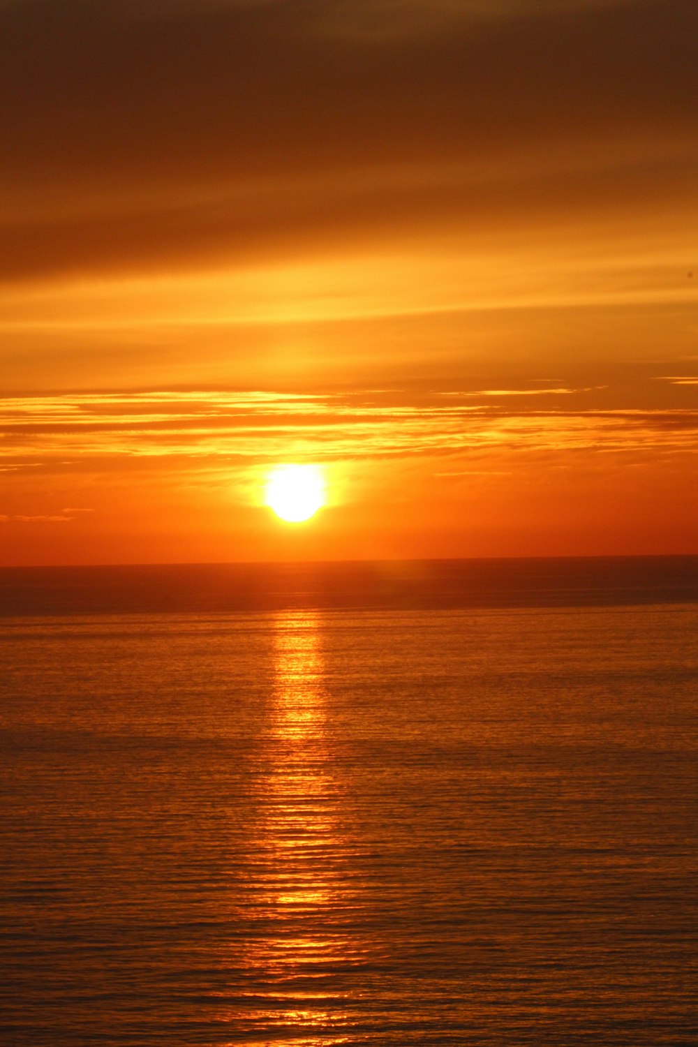 Sonnenuntergang über dem Meer mit Wolken