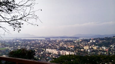 city with high rise buildings under white sky during daytime
