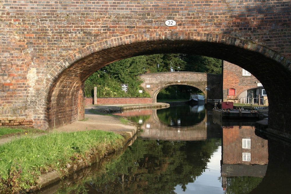 brown brick arch bridge over river