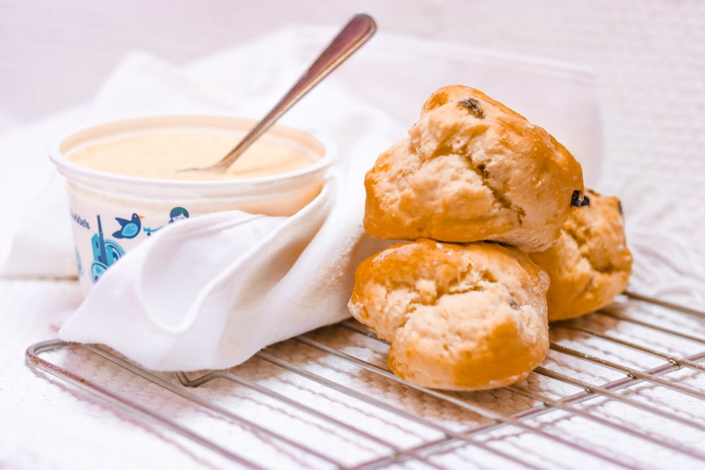 bread on white ceramic plate beside white ceramic bowl