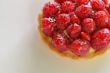 Close-up of an elegant French pastry with delicate cream swirls and fresh berries on top