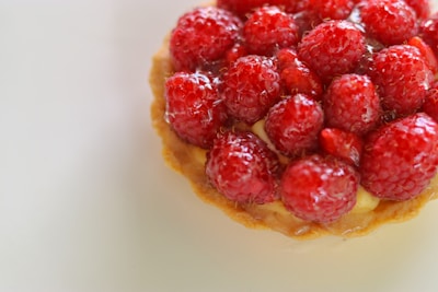 A close-up of a berry-filled Danish pastry with glistening glaze