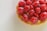 Close-up of a beautifully decorated French pastry with delicate icing and fresh berries.