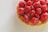 Close-up of a beautifully decorated French pastry with delicate icing and fresh berries.