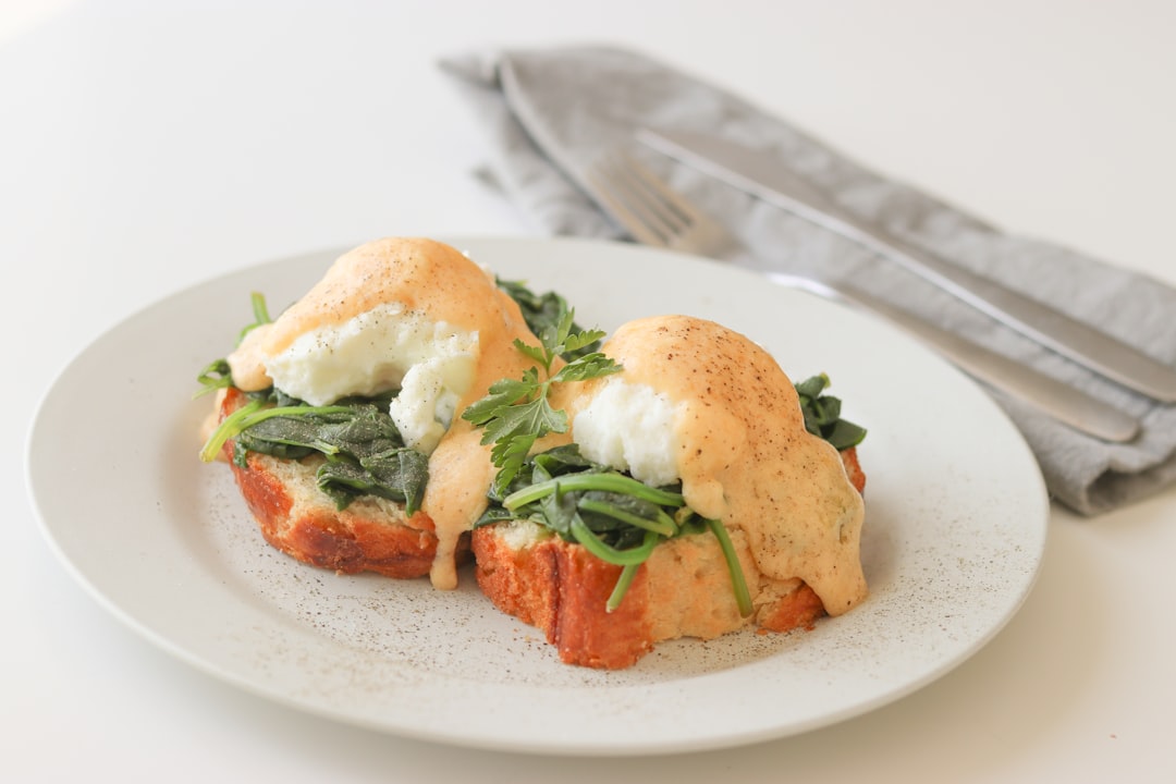 cooked food on white ceramic plate, Eggs Florentine with a special hollandaise sauce