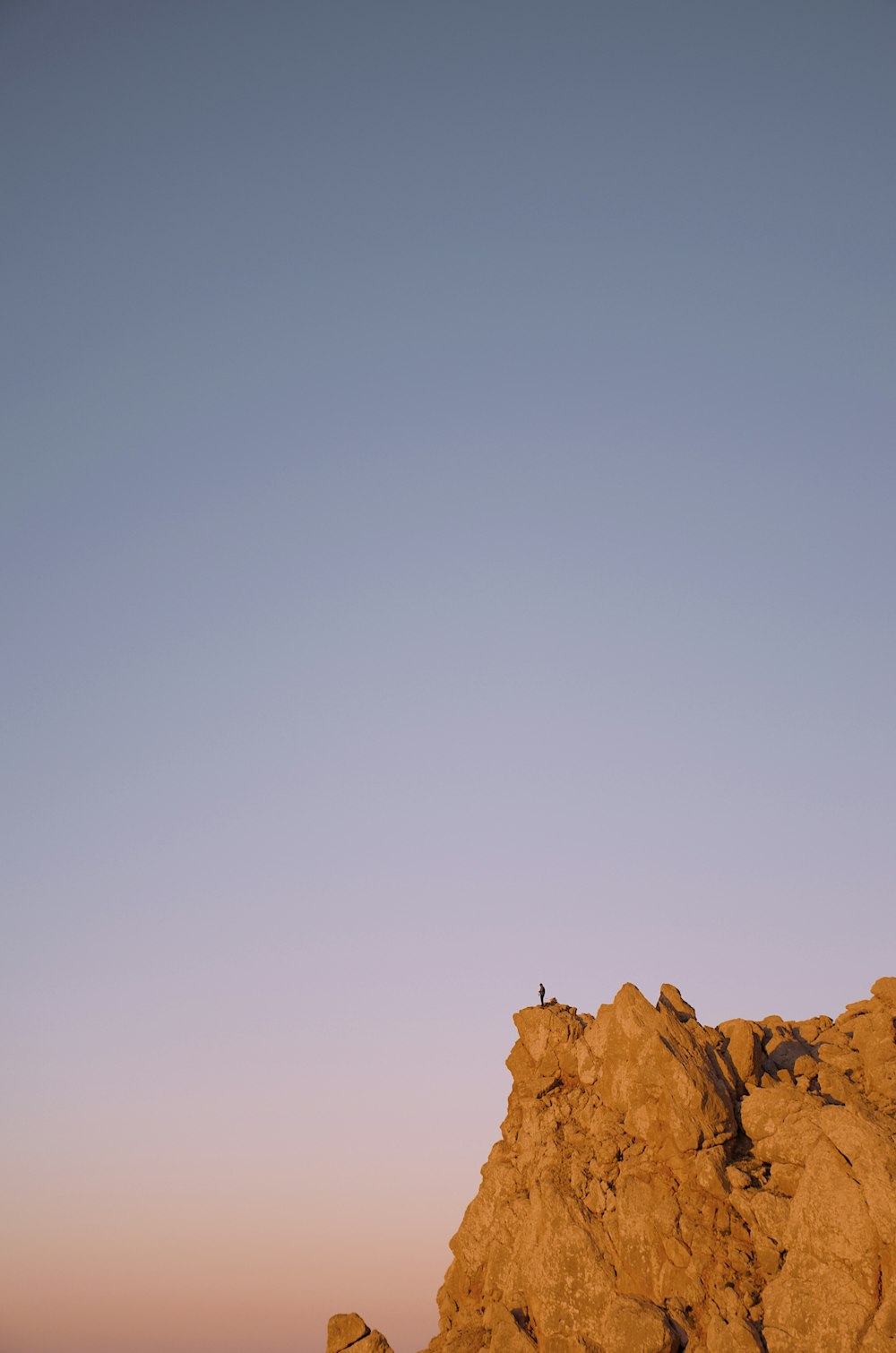 brown rock formation under white sky during daytime