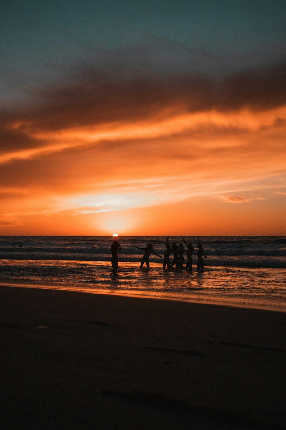 silhouette of people on beach during sunset