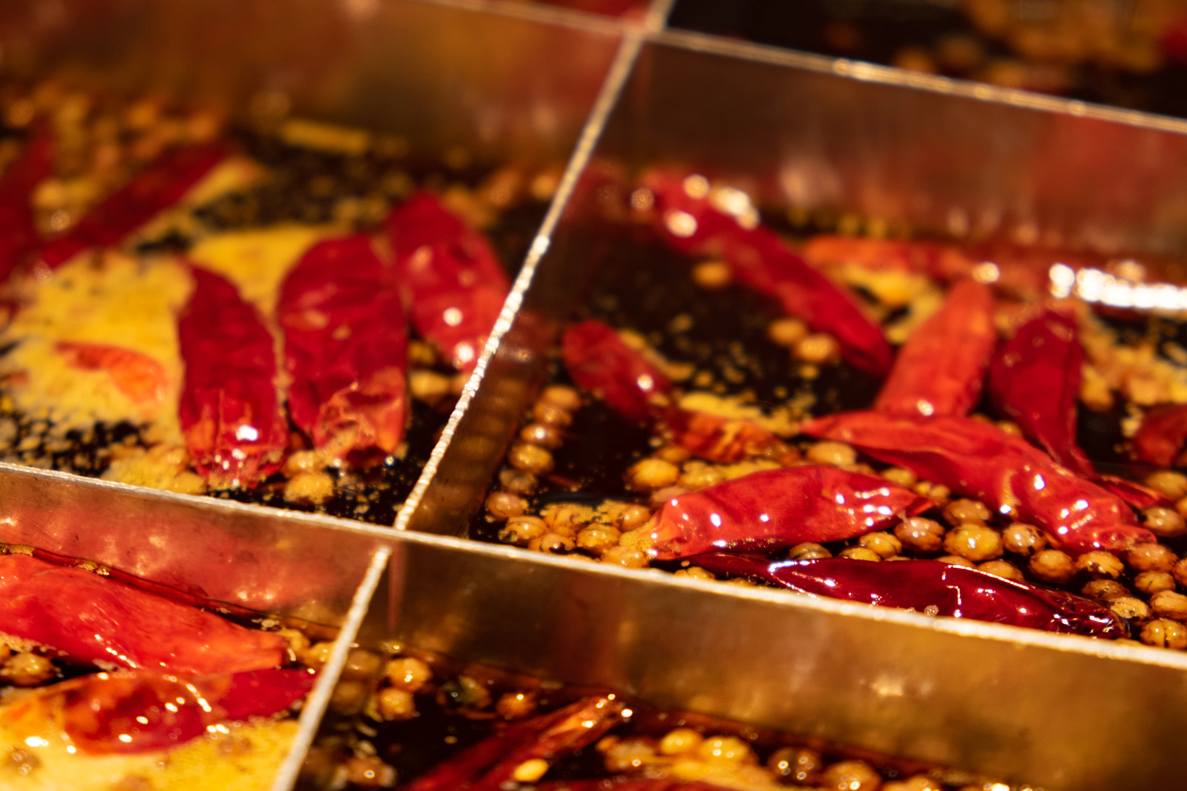 A red-orange spicy noodle soup in a bowl